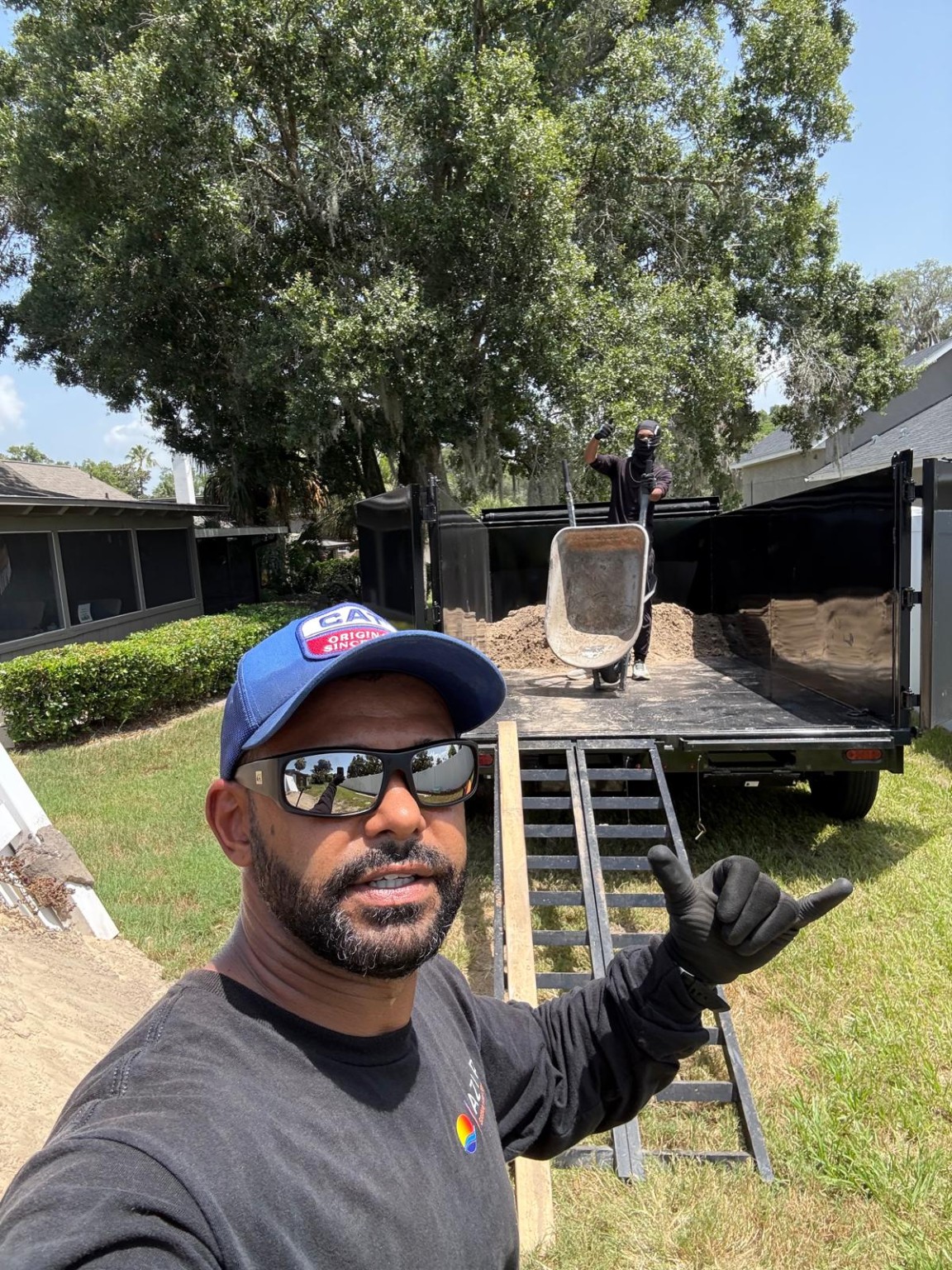 Carlos Junk Removal team working with a hauling trailer